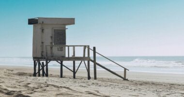 best beaches in Argentina white wooden lifeguard house on beach shore during daytime