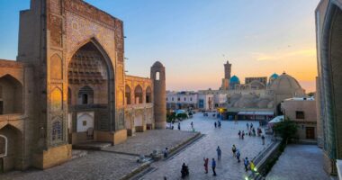 Uzbekistan Ancient architecture and a bustling public square.